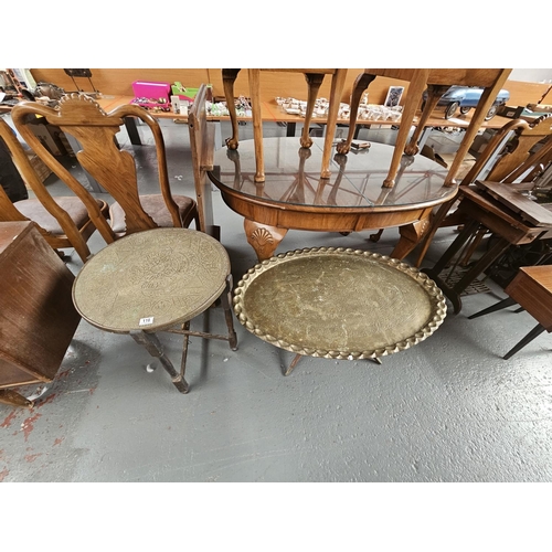 116 - One circular and one oval brass top folding tables