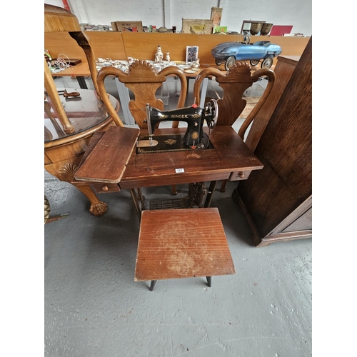 117 - A Singer sewing machine and treadle together with a sewing box