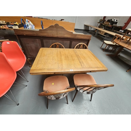 121 - An Ercol draw leaf dining table and four Ercol Fleur de Lys dining chairs