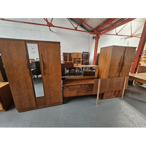 124 - A teak bedroom suite consisting of two wardrobes, dressing table and a headboard