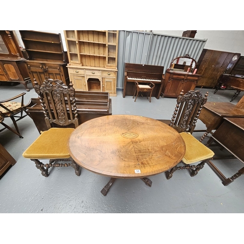 128 - A tilt top mahogany dining table and two chairs