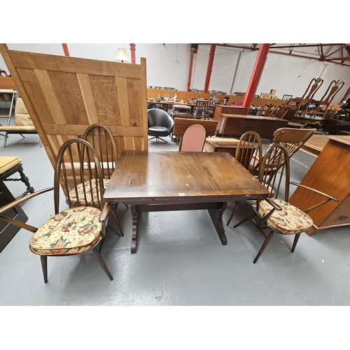 140 - An Ercol draw leaf dining table and four chairs