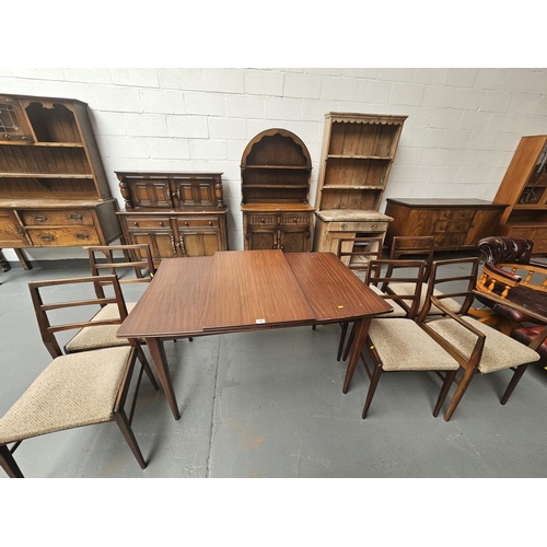 148 - A teak extending dining table with one extra leaf and six chairs