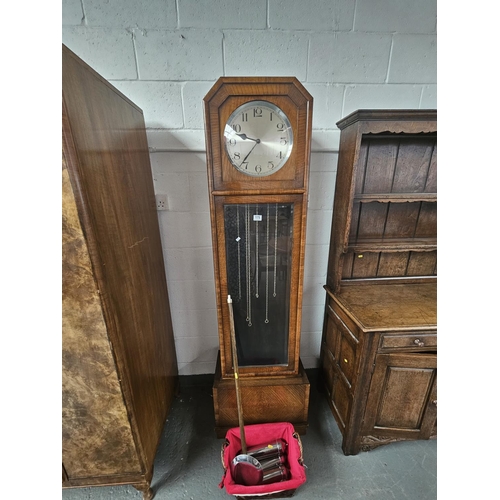 175 - An oak cased Grandfather clock with weights and pendulum