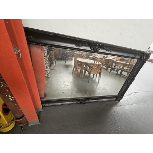 177 - A large black framed mirror