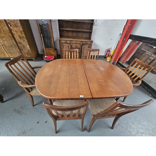 179 - A teak oval extending dining table and six chairs