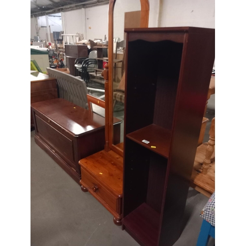 375 - A pine blanket box, cheval mirror and a bookcase