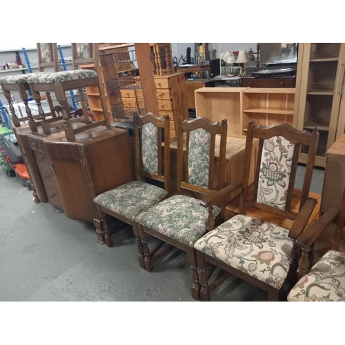 385 - An oak sideboard and six oak framed chairs including two carvers