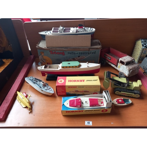 48 - A good collection of tinplate toys - a boxed Hornby speedboat, a boxed Triang radio controlled ship,... 