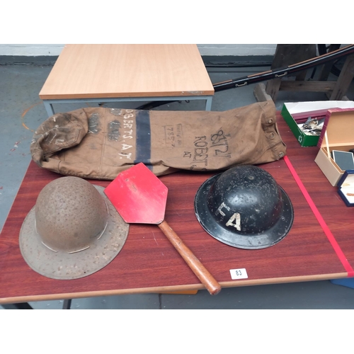 83 - Miltiary folding shovel, 2 x tin hats and a kit bag