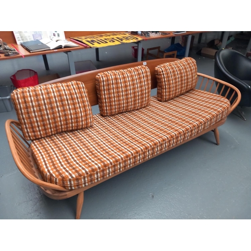 105 - An Ercol three seater sofa