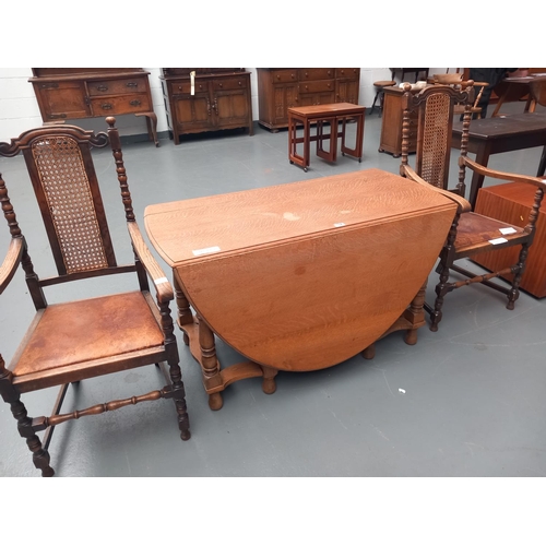 114 - An oak drop leaf dining table together with two oak frame chairs