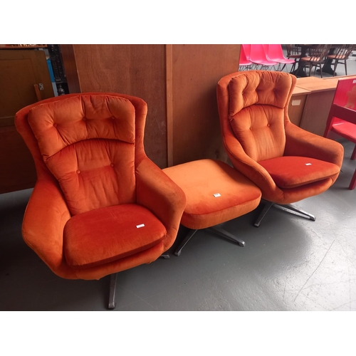 136 - Two orange fabric swivel chairs with one footstool