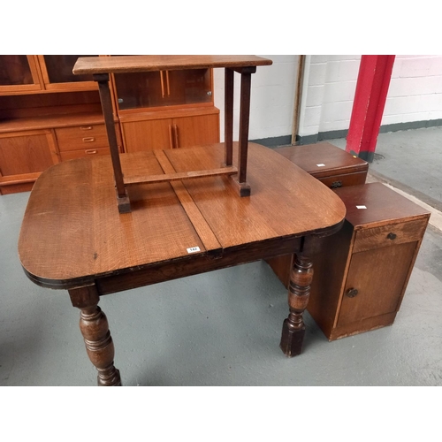 142 - An oak extending dining table, two bedside cabinets and an oak side table