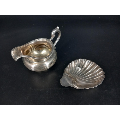 221 - A hallmarked silver jug - London John Septimus Beresford C1840 together with a silver scallop dish -... 