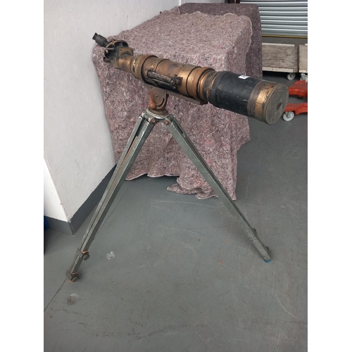 255 - A large brass military telescope/gun sight on tripod stand, military markings telescope, 34 inches i... 