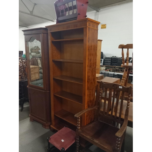 362 - A mahogany corner cabinet, tall bookcase, oak armchair, magazine rack and a footstool