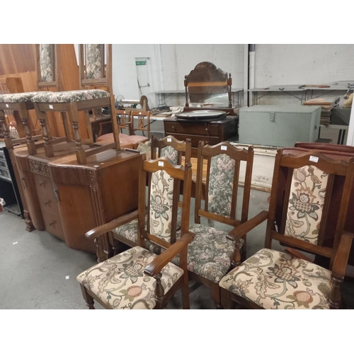 392 - An oak sideboard and six oak framed chairs including two carvers