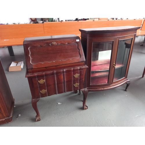 111 - A mahogany bureau together with a bowed glass fronted display cabinet