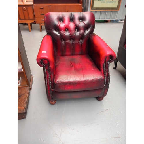 123 - A red leather Thomas LLoyd chesterfield  armchair