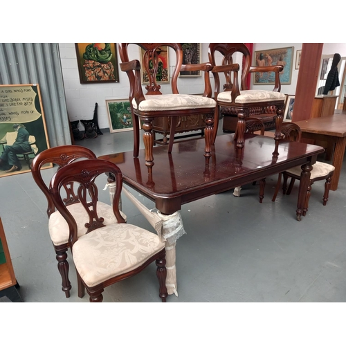 126 - An extending victorian style mahogany dining table and six chairs including two carvers