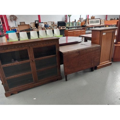 129 - An oak glass fronted bookcase, drop leaf dining table and a marble top pot cupboard