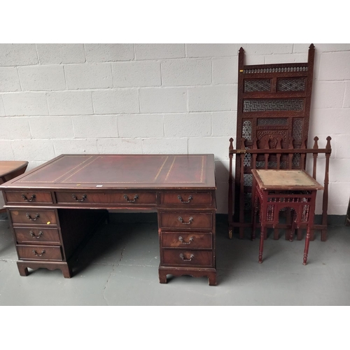 133 - A twin pedestal desk with red leatherette insert, table and a carved panel