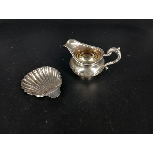 223 - A hallmarked silver jug - London John Septimus Beresford C1840 together with a silver scallop dish -... 