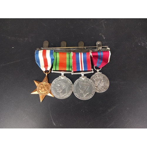 224 - A group of 4 world war 2 medals - the France and Germany star, the Defence medal, the War medal and ... 