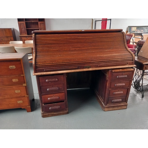 116 - A twin pedestal oak roll top desk