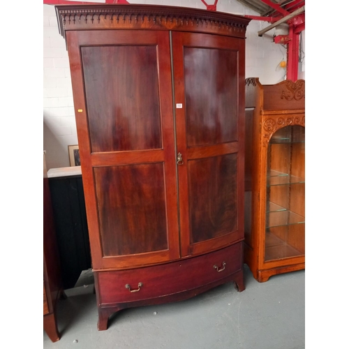 123 - A mahogany bow fronted double wardrobe