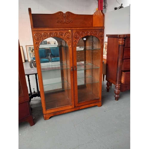 124 - An oak glass fronted display cabinet