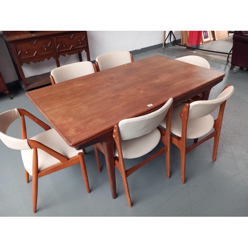 132 - A mid century teak danish extending dining table and six chairs (including two carvers) by designed ... 