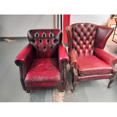 137 - A red leather chesterfield wingback armchair together with a red leather thomas lloyd armchair