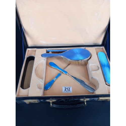 212 - A cased dressing table set - hallmarked silver and engine turned enamel.  Missing the mirror and the... 