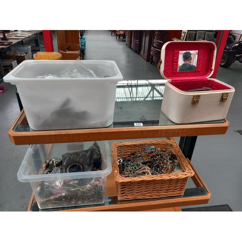 231 - A quantity of costume jewellery displayed over two shelves