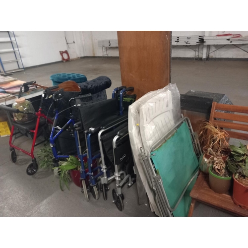 587 - Two wheelchairs, mobility aids, folding garden chairs etc