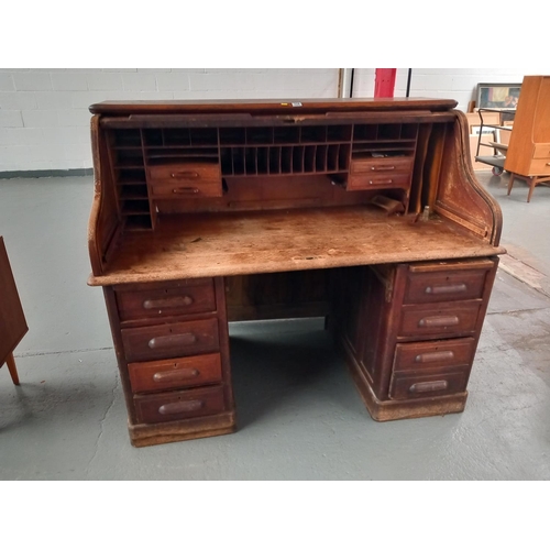 114 - A twin pedestal oak roll top desk