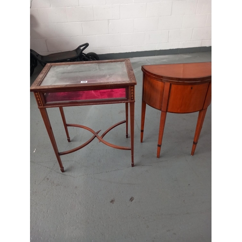 128 - A bijouterie display cabinet (damage to support) and a half circular sewing box