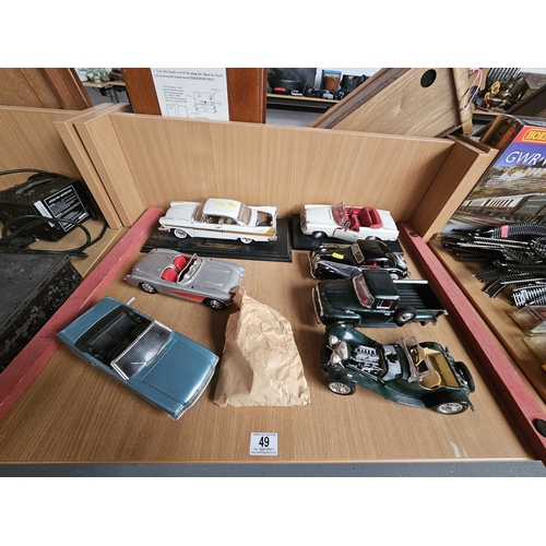 49 - Seven 1:18 scale model cars including 1957 Plymouth, Mercedes Benz 280 SE, Chevrolet Corvette, etc