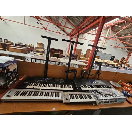 62 - A Technics KN2000 PCM keyboard, a Casio HT-6000 keyboard and two Roland keyboards