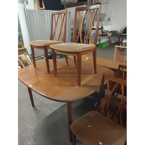 607 - A teak extending dining table and four chairs