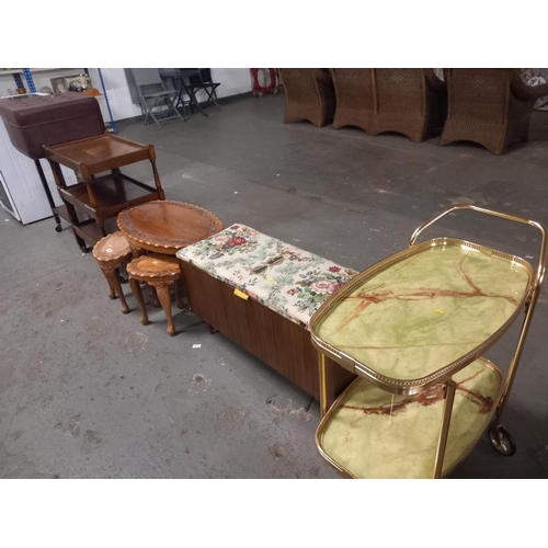 619 - A leather foot stool, ottoman, nest of tables and two drinks trolleys