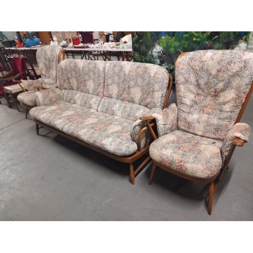 625 - An ercol two seater sofa and two matching arm chairs