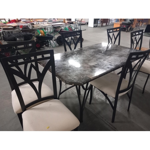 635 - A marble effect topped metal based dining table and six chairs