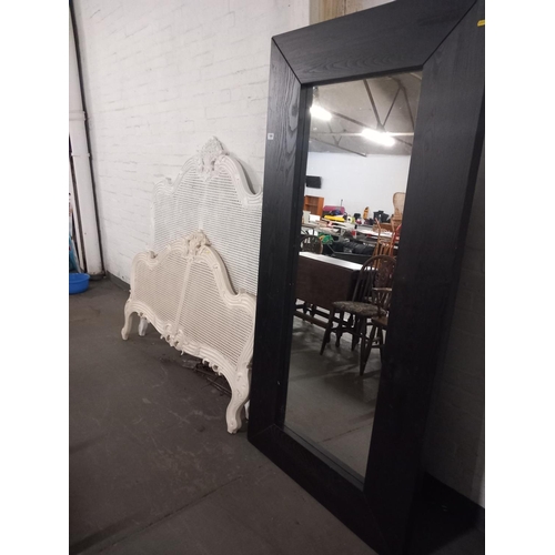 644 - A large mirror and a wicker double bed frame