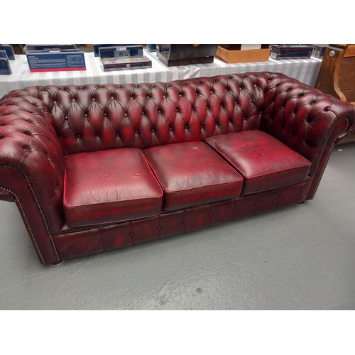 105 - Red leather chesterfield three seater sofa