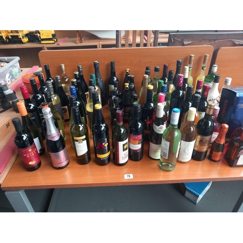 78 - An alcohol lot - red and white wines, beer and spirits to include Gordons gin, Malibu, Courvoisier c... 