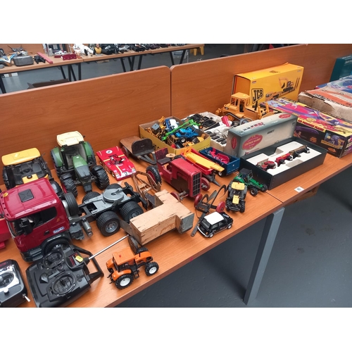 83 - Boxed and loose tractors, car racing sets and other wooden toys