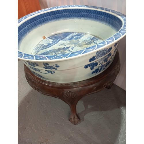 101 - A chinese 18th/19th century large blue and white washbowl on wooden stand 26 inches in diameter and ... 